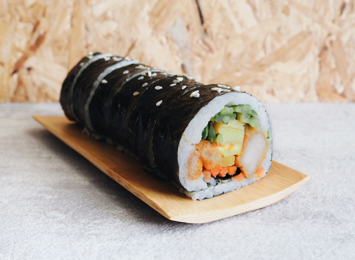 A delicately rolled kimbap cut into several bite sizes.